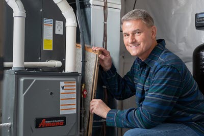 Pete from PowerHouse in front of a furnace