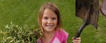 Girl with shovel and tree