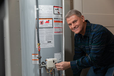 Pete from PowerHouse adjusting a water heater
